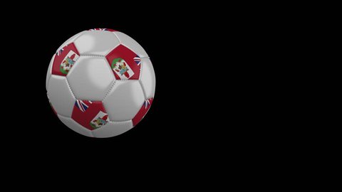 Soccer ball with the flag of Bermuda flies past the camera, slow motion, 4k footage with alpha channel