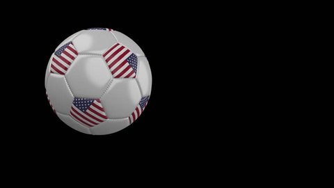 Soccer ball with the flag of United States of America flies past the camera, slow motion, 4k footage with alpha channel