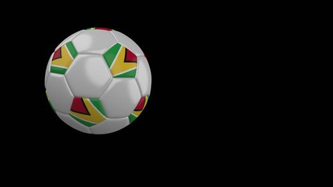 Soccer ball with the flag of Guyana flies past the camera, slow motion, 4k footage with alpha channel