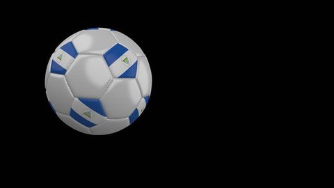 Soccer ball with the flag of Nicaragua flies past the camera, slow motion, 4k footage with alpha channel