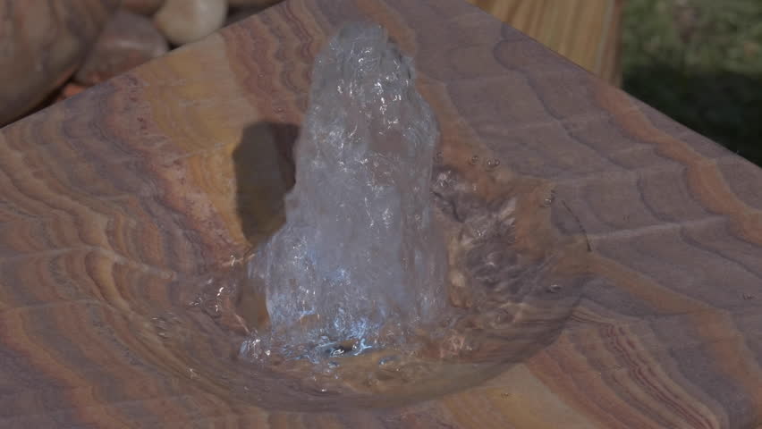 Garden water feature with water bubbling from the top of the stone