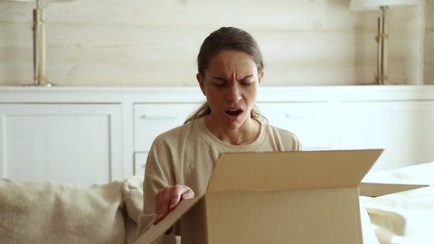 Dissatisfied annoyed female customer open cardboard box receive damaged broken parcel, shocked young woman consumer having problem complaint frustrated with bad shopping order delivery post shipping