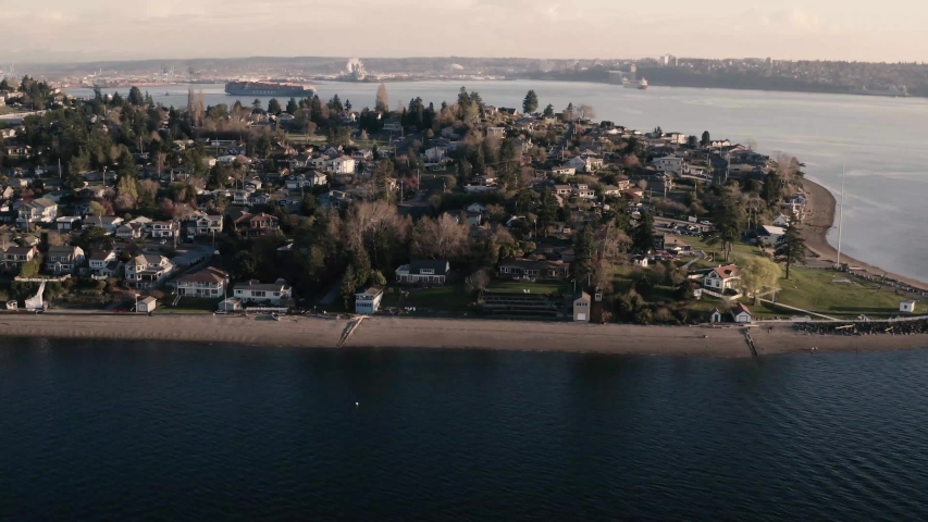 Drone footage of the seaside residential area of North Tacoma, Browns Point with the park and historical lighthouse in Washington