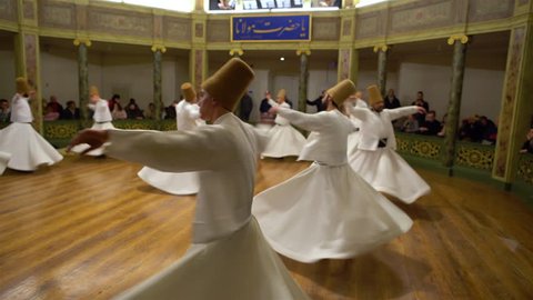 Traditional dances of dervishes in white clothes in Galata Mevlevihanesi. Sufi whirling dervish. Spiritual gift to those witnessing ritual.He spins with the music. TURKEY, Istanbul January 13, 2019