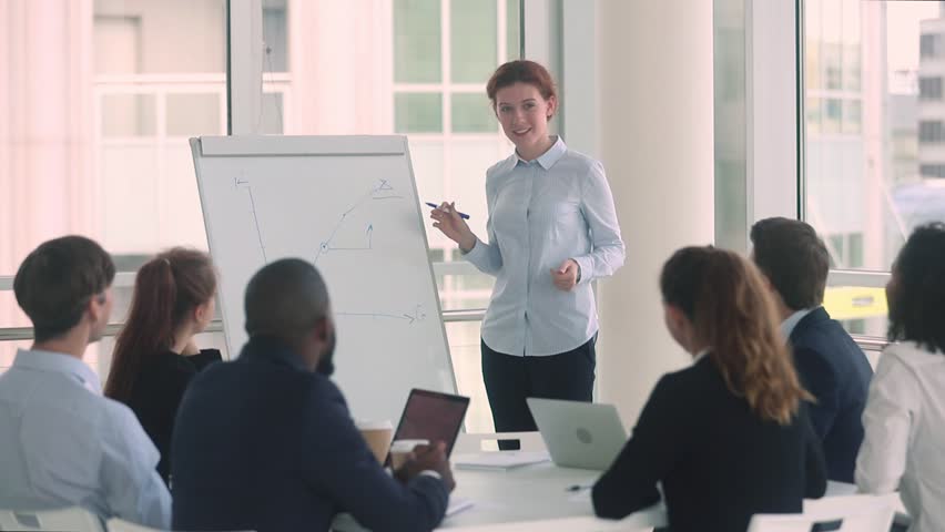 Positive skilled trainer makes presentation show line graph on flip chart, diverse audience applauding claps hands to speaker coach thanking for seminar and presentation appreciating lecturer concept Royalty-Free Stock Footage #1029333371