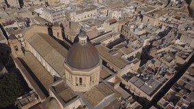 Aerial bird view video of south side of Italian city Marsala. European buildings and seaside. Summer day lightning
