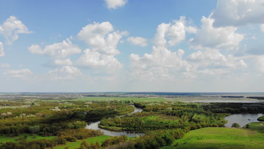 Aerial view time lapse movement of clouds in the blue sky and beautiful meadow and river.