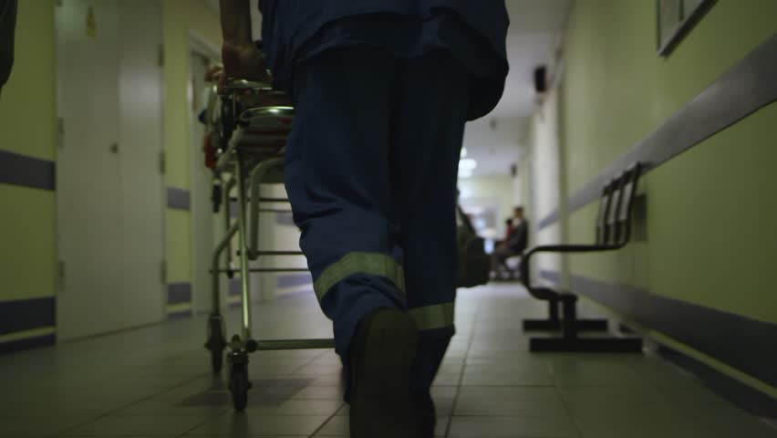 Doctors carry the patient along the corridor in hospital Royalty-Free Stock Footage #1029346037