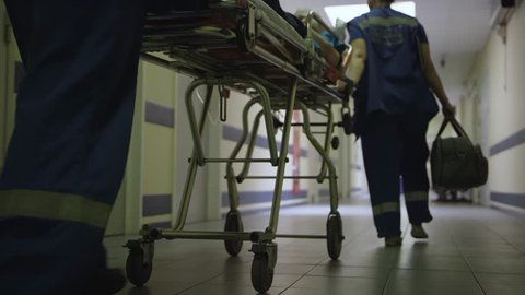 Doctors carry the patient along the corridor in hospital