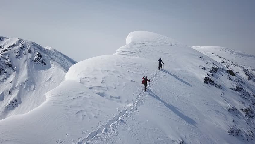 Climbers Walking Up Mountain Expedition Aerial Flight Epic Mountain Range Climb To Success Beautiful Peak Winter Vacation Exploration Adventure Hiking Tourism Concept. Royalty-Free Stock Footage #1029348443