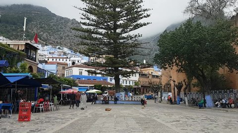Chefchaouen, Morocco - May 4, 2019: People walking in Outa el Hammam square in Chefchouen, Morocco