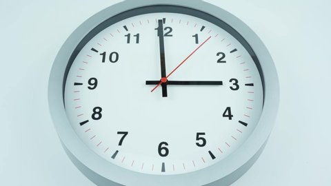 Closeup White clock face beginning of time 03.00 am or pm with Black numbers and arrows, Red second hand minute Walk Time lapse moving fast.