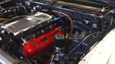 Engine compartment of a sports car upgraded. Powerful motor in a modern car. Racing tuning.