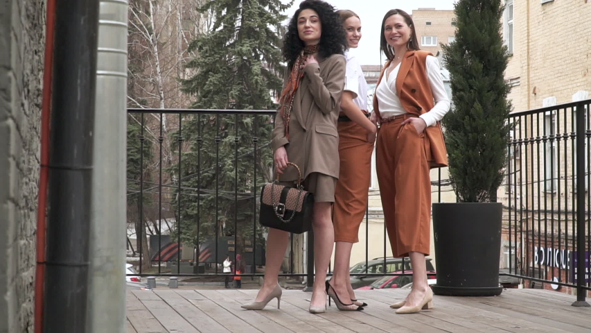 HD Footage. Slowmo. Three beautiful young girls in business suits. Business style. Posing at a photo shoot in the studio. | Shutterstock HD Video #1029365408
