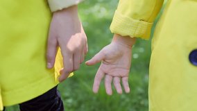 video of two young children holding hands in the park
