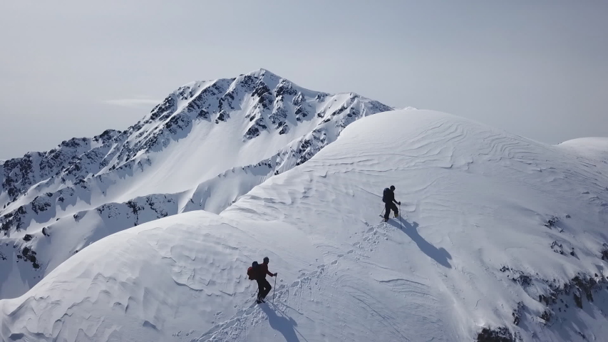 Climbers Walking Up Mountain Expedition Aerial Flight Epic Mountain Range Climb To Success Beautiful Peak Winter Vacation Exploration Adventure Hiking Tourism Concept. Royalty-Free Stock Footage #1029370106