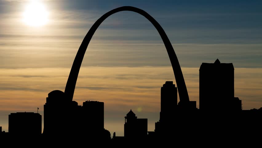 St. Louis Cityscape at Sunset with Sun, Clouds, Skyscrapers and Iconic Gateway Arch in Time Lapse, Missouri, USA