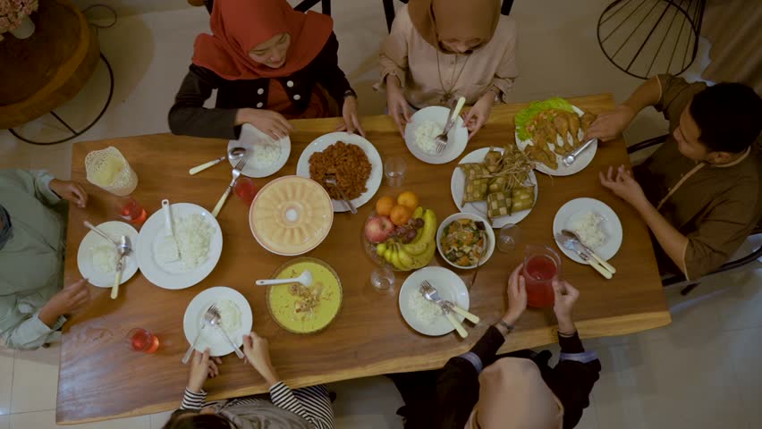 Family together in the dining room, a moments together with family breaking their fast in ramadan Royalty-Free Stock Footage #1029379352