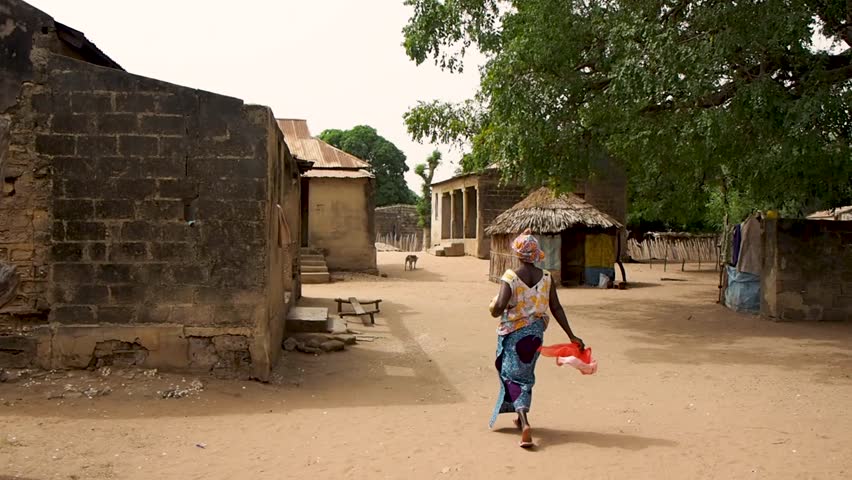 walking down a street in a small village in Senegal