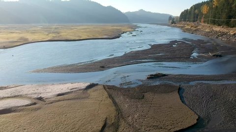 Aerial drone footage towards the end of summer at Alder Lake in Washington State USA. Here we see a dried lake bed with stumps from when the area was flooded for the dam downstream.