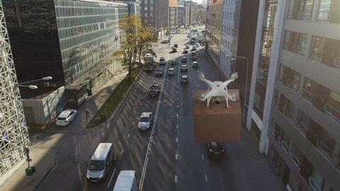 Aerial View of a Quadcopter Drone Flying with a Big Brown Parcel in the City. Logistics Drone Delivering Package to Your Home. Futuristic Shipment by Helicopter Drone.