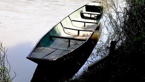 Long empty steel canoe on the river Ing Thoeng Chiang Rai Thailand