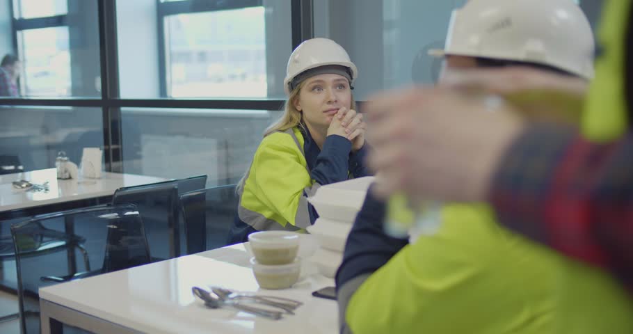Lunch break at industrial factory. Group of engineers having meal in canteen. Royalty-Free Stock Footage #1029394343