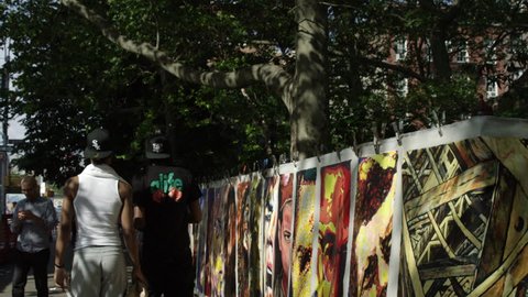 NEW YORK - MAY 30, 2015: street art, portraits, famous people, celebrity paintings, drawings, pictures, Marilyn Monroe, JFK, Bob Marley, Malcolm X, slow motion 4K, NY. West Village is in NYC, USA.