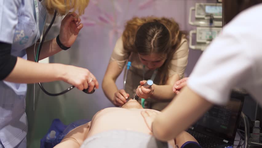 BELARUS, MINSK - MARCH 13, 2019: Emergency, training of medical personnel and ambulance doctors, tracheal intubation, doctors reanimate a man's dummy.