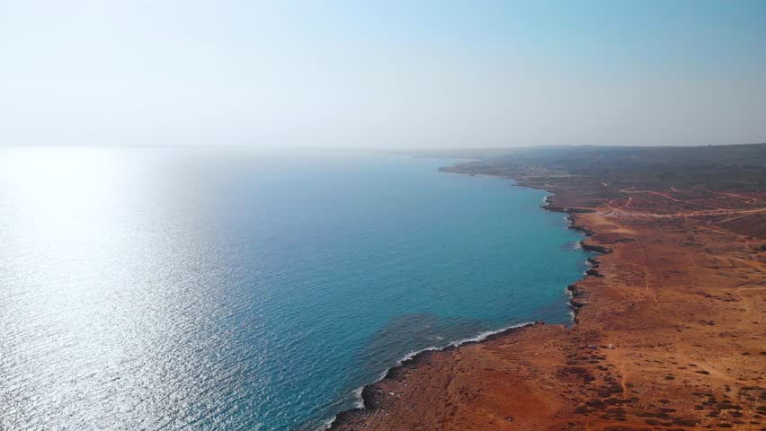 Aerial shot flying over the rocky coast of Cavo Greko in Cyprus