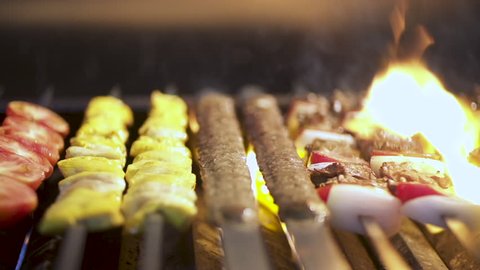 Cook roasts juicy kebab barbecue on the coal grill, slow motion