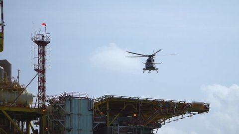 Helicopter landing on oil and gas platform helideck, Helicopter transfer crews or passenger to work in offshore oil and gas industry, air transportation for support passenger.
