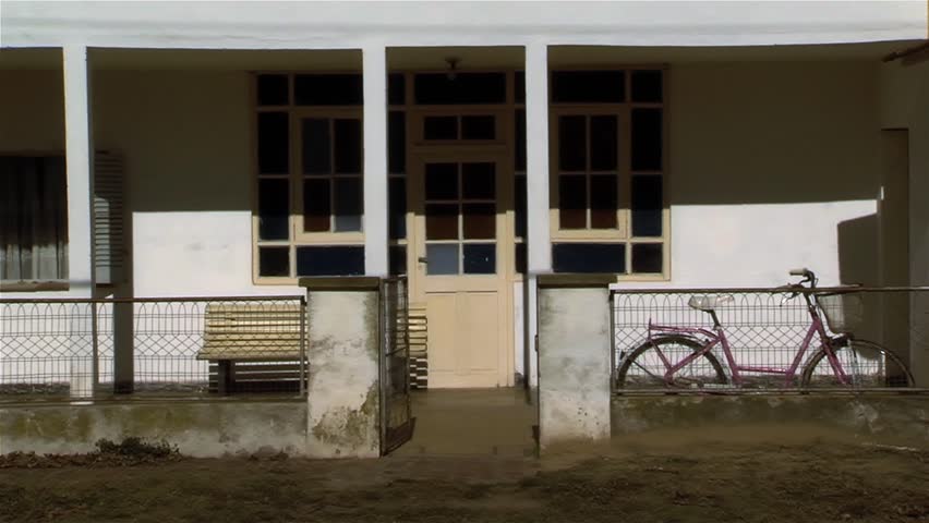 Vintage Bicycle Parked Against Fence at the Porch of an Old House in Argentina.