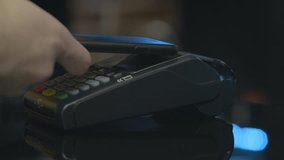 Man paying with NFC technology with smart phone credit card application in clothing store, close-up, point of view, young handsome student male in shopping mall atm banking wallet. - Powered by Shutterstock - Get 15% off with code: PIKWIZARD15