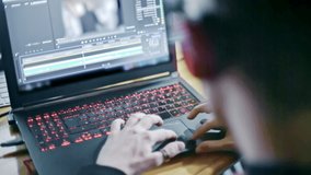 Professional video editor working on a laptop