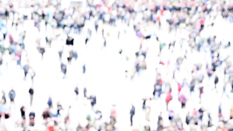 Intentionally blurred abstract aerial  image of crowd of unrecognizable people walking in the city. High key, bleached effect. Concept for business, shopping, modern life, management, corporate, ghost