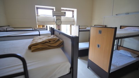 Empty room for a cheap hostel with bunk beds.