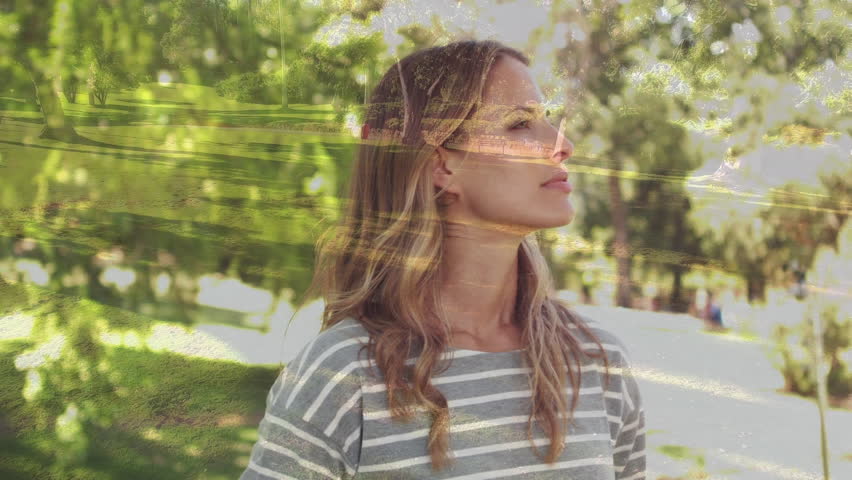 Side view of a Caucasian woman looking up in a park