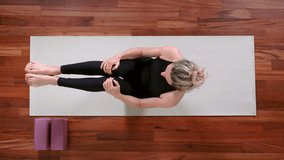 Top view of young woman doing Yoga exercise at home. Pilates 100.