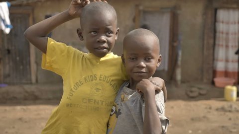 Two happy African kids are looking and smiling in Kenyan slums, Nairobi, Kenya (April 2019)