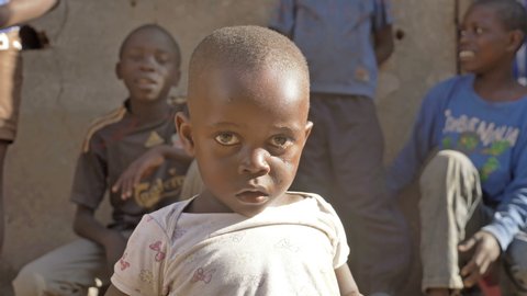 A tearful Kenyan kid looking at the camera in the slums of Kibera, Nairobi, Kenya (April 2019)