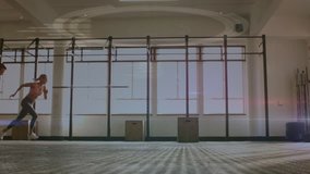 Full view of two Caucasian athletes sprinting in the gym. Digital animation of a DNA helix with labels is running the foreground - Powered by Shutterstock - Get 15% off with code: PIKWIZARD15