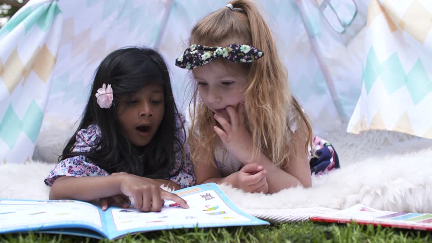 Happy Girls Reading Book In Kids Tent in Graden
