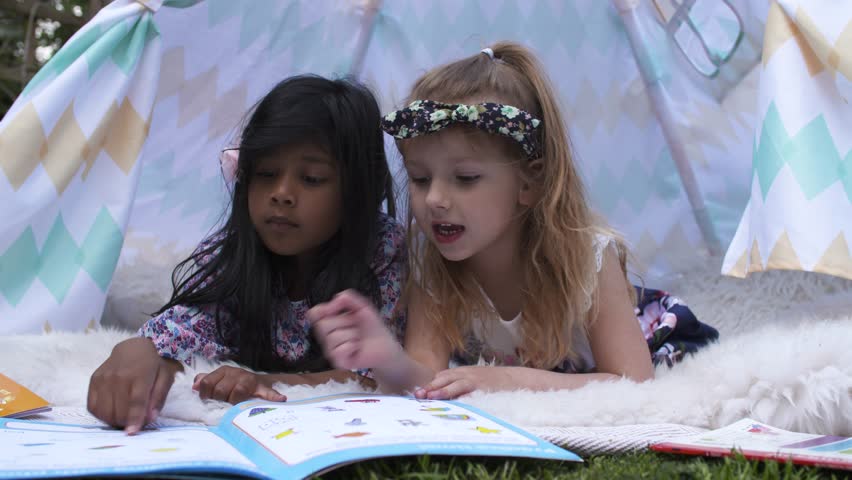 Happy Girls Reading Book In Kids Tent in Graden