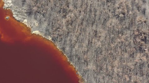 Above red acidic mine drainage waters 4K aerial video