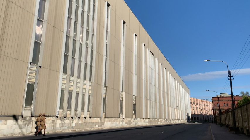 two girls in military uniform walking down the street