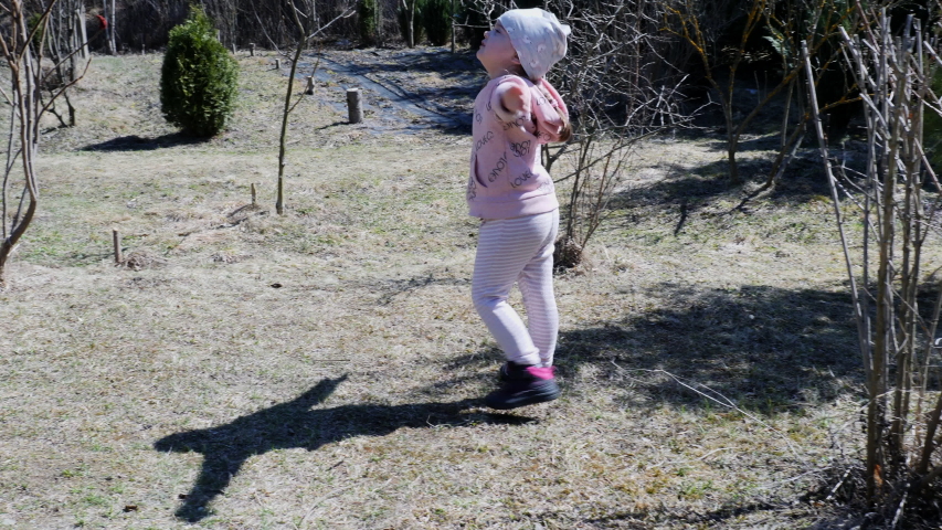 Happy little girl in the orchard. 4K