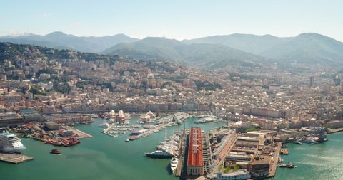 Aerial view of panorama of Genoa city center and industrial maritime port in a sunny day.