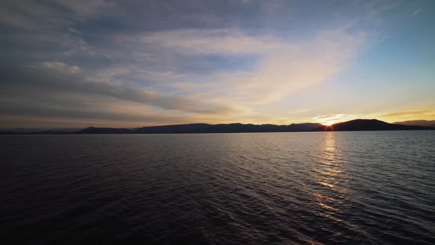 Beautiful sunrise sea and sky with mountains. Sunset sky over the sea.