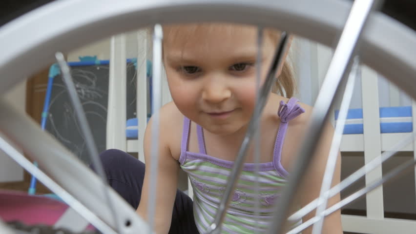A little girl sitting on the floor in the children